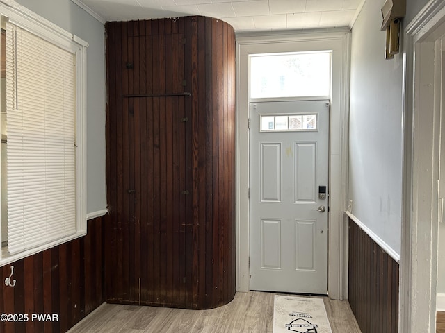 887 Maple Ave, Honesdale, PA 18431 - doorway to outside with light wood finished floors, a wainscoted wall, and wood walls