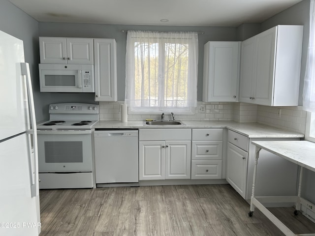 887 Maple Ave, Honesdale, PA 18431 - kitchen with a sink, white appliances, white cabinetry, decorative backsplash, and light countertops