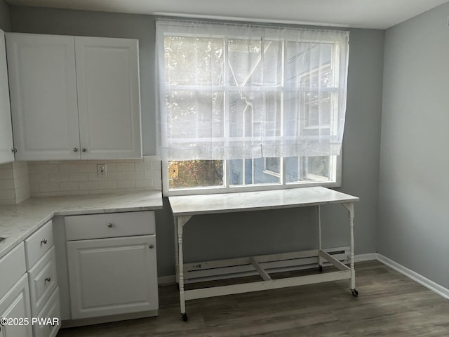 887 Maple Ave, Honesdale, PA 18431 - interior space featuring decorative backsplash, dark wood-style floors, baseboards, and white cabinets