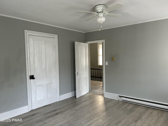 887 Maple Ave, Honesdale, PA 18431 - unfurnished bedroom with a ceiling fan, wood finished floors, baseboards, and ornamental molding