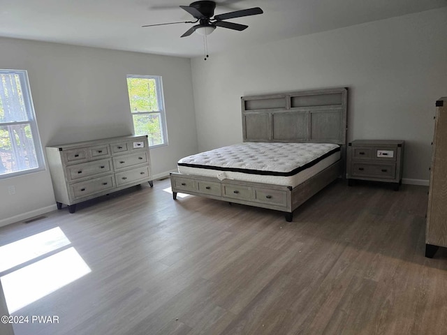 bedroom featuring ceiling fan and dark hardwood / wood-style floors