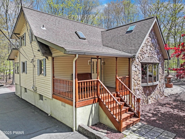 109 Glenbrook Dr, Dingmans Ferry, PA 18328 - chalet / cabin featuring a shingled roof, covered porch, and stone siding