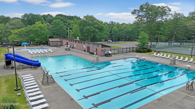 109 Glenbrook Dr, Dingmans Ferry, PA 18328 - community pool featuring a patio and view of wooded area