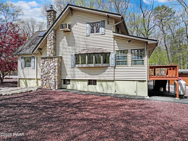 109 Glenbrook Dr, Dingmans Ferry, PA 18328 - view of home's exterior with a wooden deck, a chimney, and a wall mounted AC