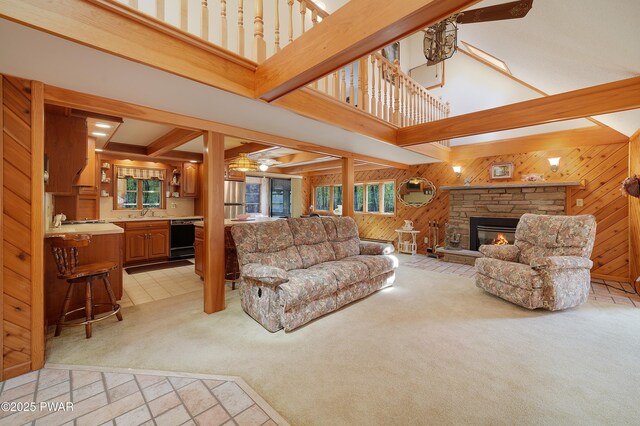 109 Glenbrook Dr, Dingmans Ferry, PA 18328 - living room with wooden walls, light colored carpet, a high ceiling, healthy amount of natural light, and a ceiling fan
