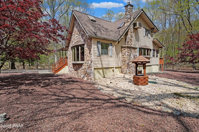 109 Glenbrook Dr, Dingmans Ferry, PA 18328 - view of home's exterior with stone siding, a chimney, and roof with shingles