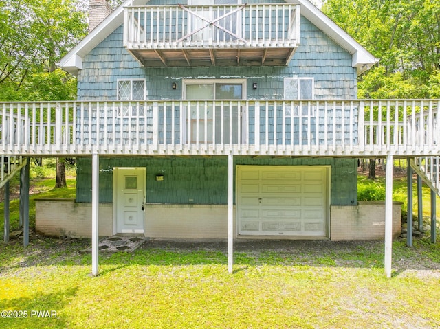 511 Overlook Ter, Stroudsburg, PA 18360 - back of house featuring a chimney, a balcony, a yard, a deck, and an attached garage