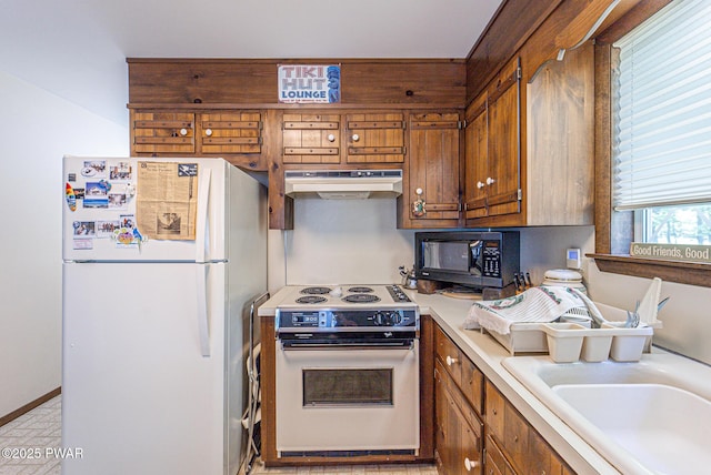 511 Overlook Ter, Stroudsburg, PA 18360 - kitchen featuring white appliances, under cabinet range hood, brown cabinetry, and light countertops