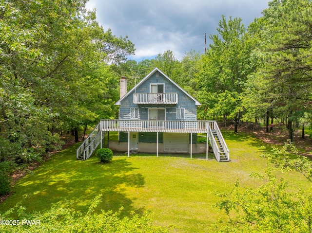 511 Overlook Ter, Stroudsburg, PA 18360 - back of property featuring stairs, a chimney, a wooden deck, a lawn, and a balcony