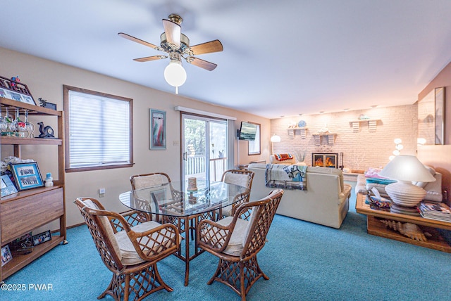 511 Overlook Ter, Stroudsburg, PA 18360 - dining room featuring carpet floors, ceiling fan, a fireplace, and brick wall
