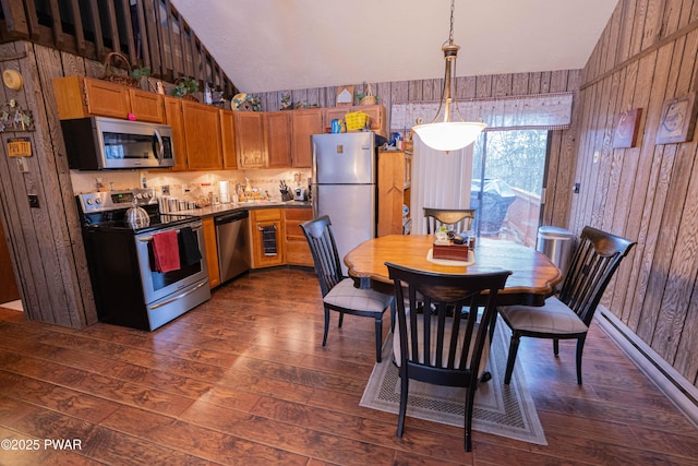 kitchen with lofted ceiling, stainless steel appliances, and dark wood finished floors