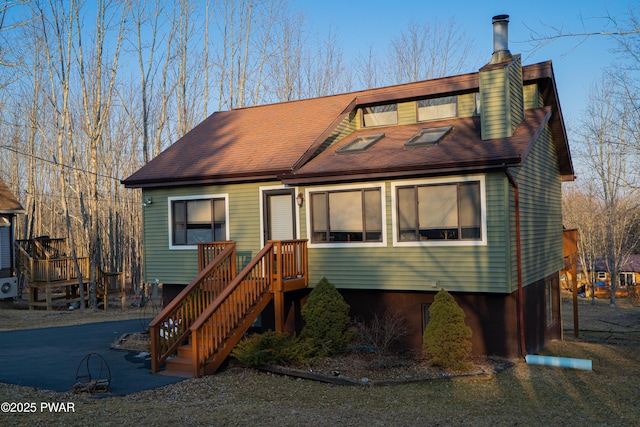 view of front of property featuring roof with shingles