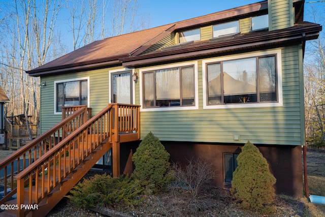 back of property featuring stairway