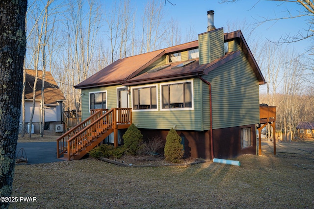 rear view of house featuring a chimney