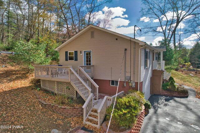 exterior space with a deck and a garage