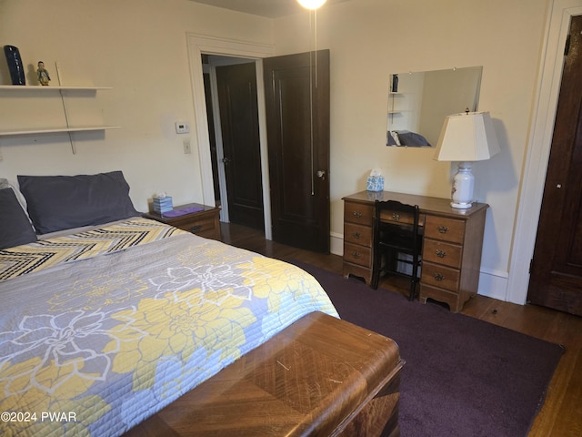 bedroom with dark wood-type flooring