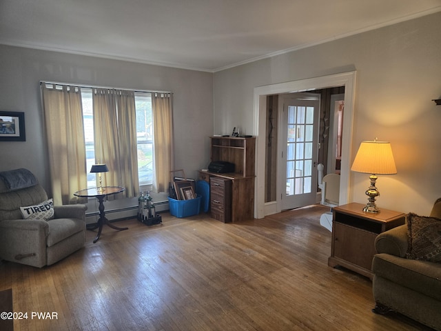 sitting room with hardwood / wood-style flooring and a baseboard heating unit