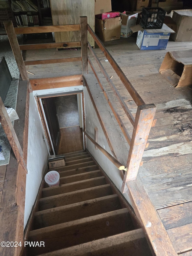 staircase with hardwood / wood-style floors