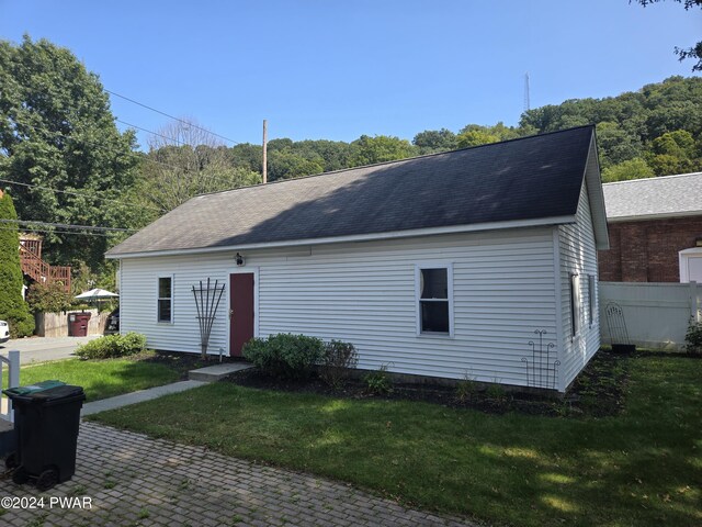 rear view of house with a yard