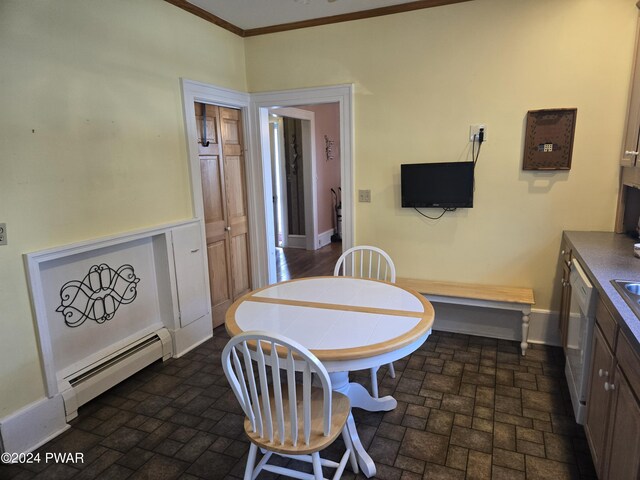 dining area featuring crown molding and baseboard heating