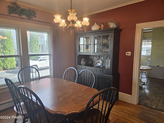 dining space featuring ornamental molding, dark wood-type flooring, plenty of natural light, and a notable chandelier