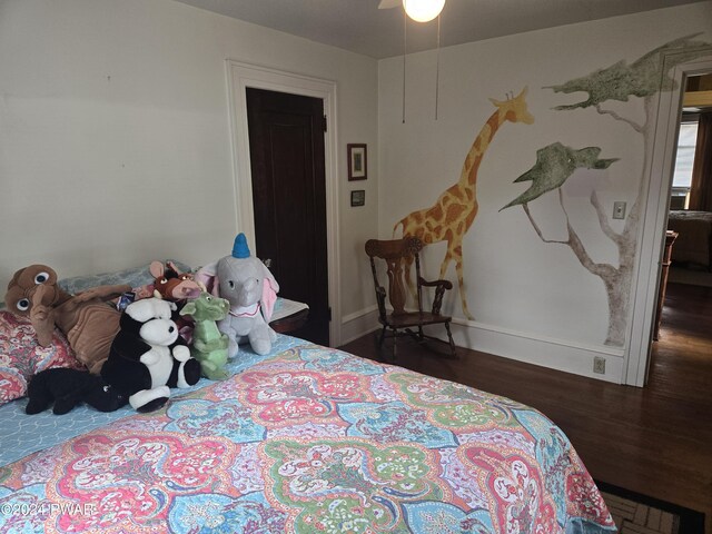 bedroom with dark hardwood / wood-style floors