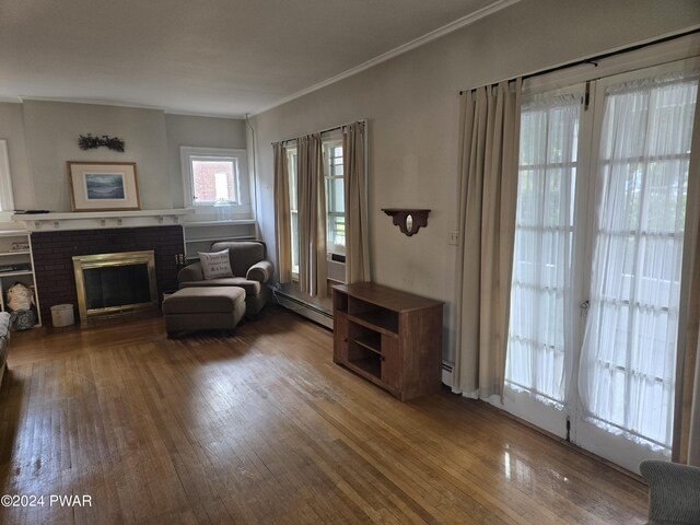 sitting room with dark hardwood / wood-style flooring, a brick fireplace, and baseboard heating