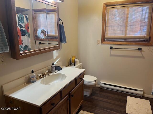 bathroom featuring a baseboard radiator, vanity, toilet, and wood-type flooring