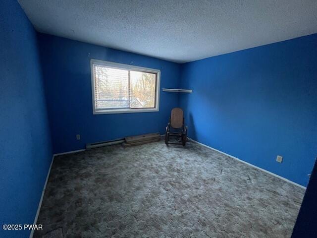 carpeted spare room featuring a textured ceiling