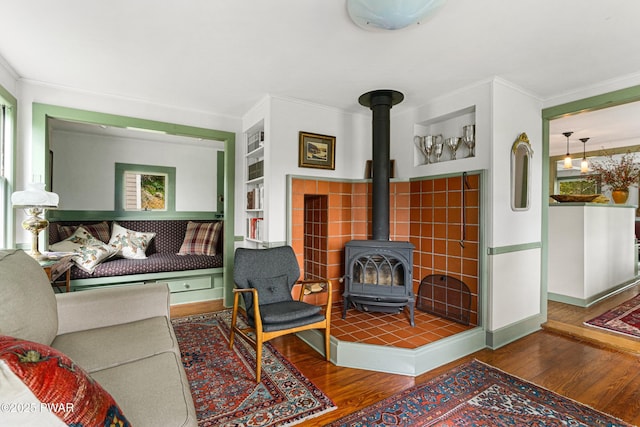 182 Lcpl Jacob Beisel Rd, Lackawaxen, PA 18435 - living room with wood finished floors, a wood stove, crown molding, baseboards, and built in features
