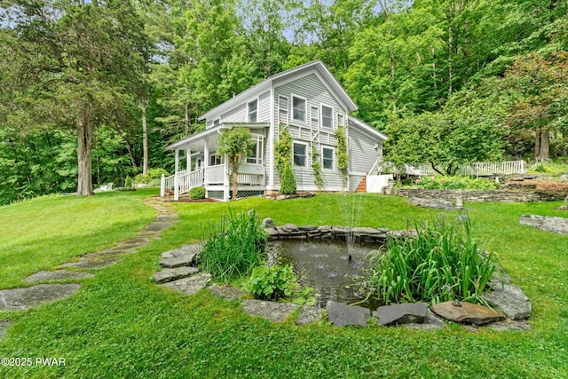 182 Lcpl Jacob Beisel Rd, Lackawaxen, PA 18435 - view of property exterior featuring a garden pond, a porch, and a lawn