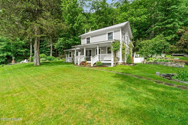 182 Lcpl Jacob Beisel Rd, Lackawaxen, PA 18435 - view of front of home featuring covered porch, a front lawn, a chimney, and metal roof