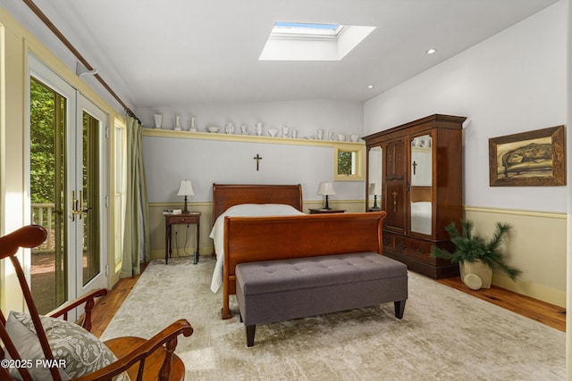 182 Lcpl Jacob Beisel Rd, Lackawaxen, PA 18435 - bedroom featuring wood finished floors, vaulted ceiling, access to outside, a skylight, and baseboards