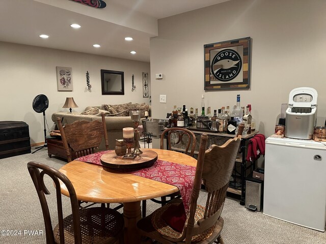 carpeted dining area featuring indoor bar