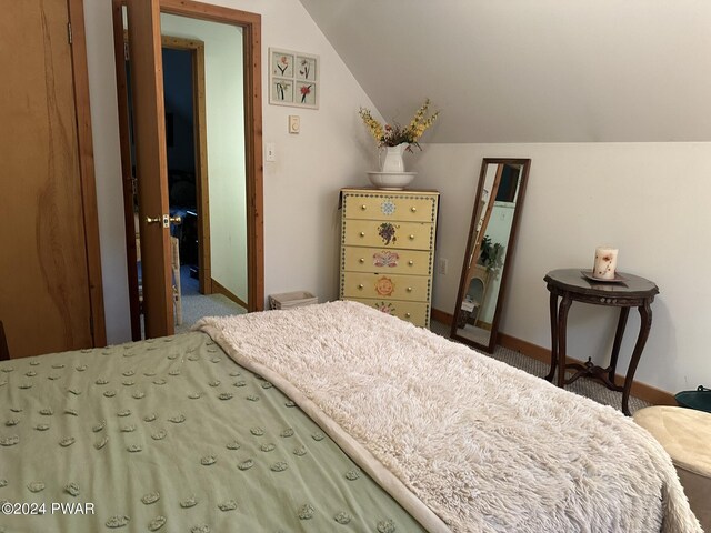 carpeted bedroom with vaulted ceiling