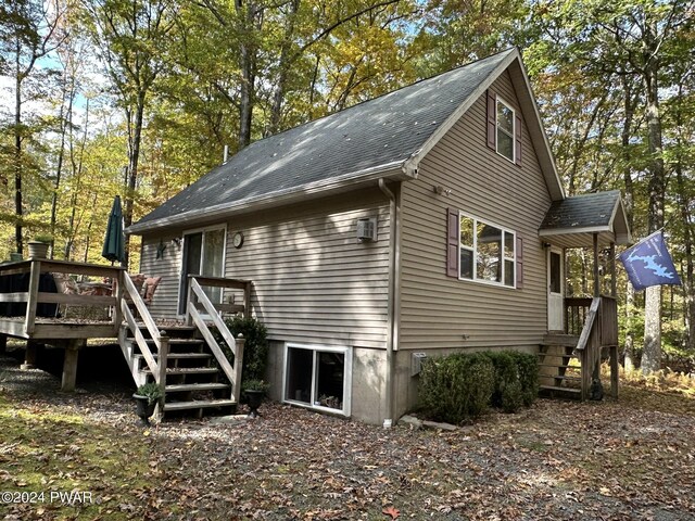 back of property with a wooden deck