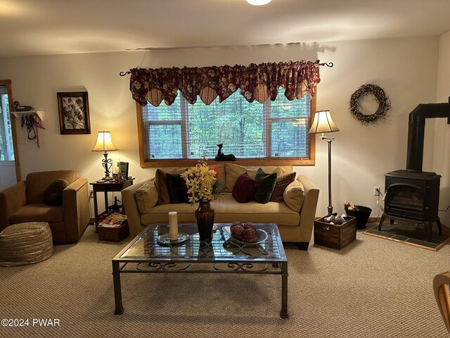 living room with carpet flooring and a wood stove