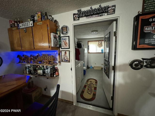 kitchen featuring white refrigerator and a textured ceiling