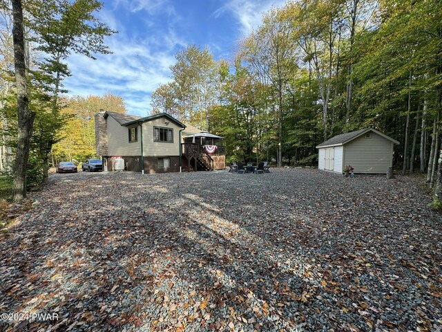 exterior space with a wooden deck and a shed