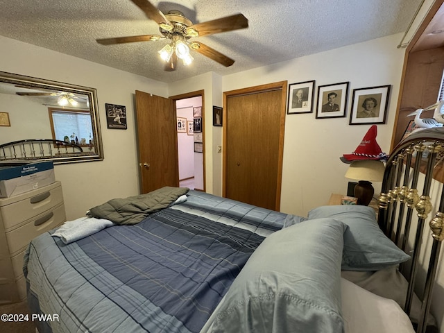 bedroom with a textured ceiling and ceiling fan