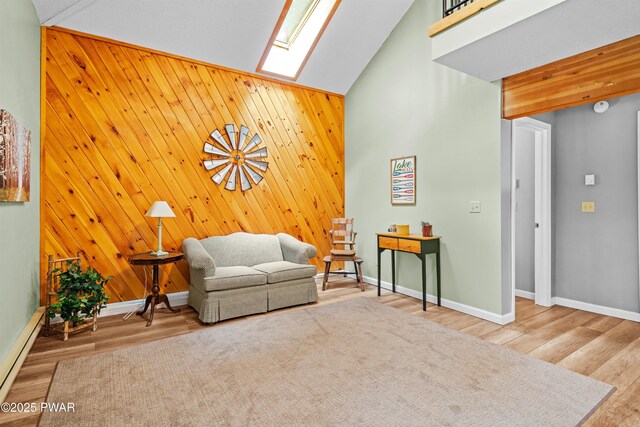 191 Water View Dr, Hawley, PA 18428 - living area with a skylight, baseboards, wood finished floors, high vaulted ceiling, and wood walls