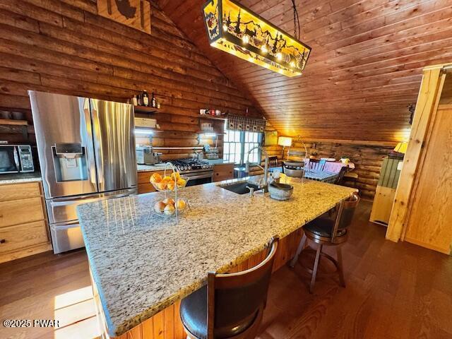 kitchen featuring appliances with stainless steel finishes, a sink, log walls, vaulted ceiling, and dark wood-style flooring