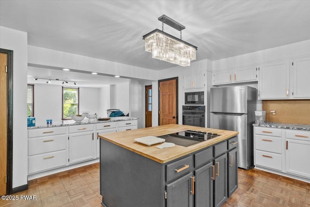 29 Hirshorn Dr, Newfoundland, PA 18445 - kitchen with black appliances, white cabinets, wood counters, and a kitchen island