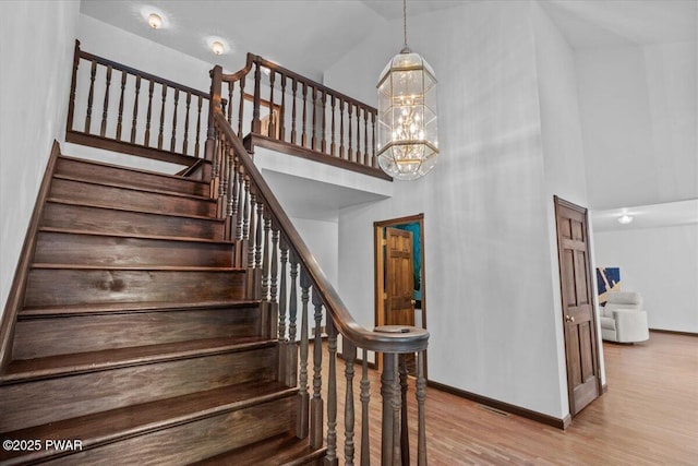 29 Hirshorn Dr, Newfoundland, PA 18445 - stairway featuring a towering ceiling, baseboards, wood finished floors, and a chandelier