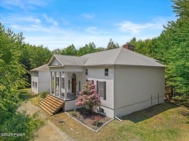29 Hirshorn Dr, Newfoundland, PA 18445 - view of front of home with covered porch, a chimney, and roof with shingles