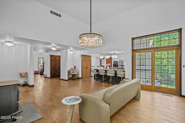 29 Hirshorn Dr, Newfoundland, PA 18445 - living room featuring a high ceiling, a chandelier, wood finished floors, and a wood stove