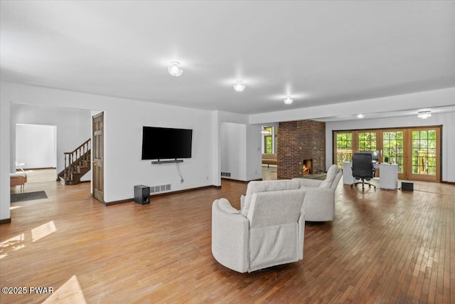 29 Hirshorn Dr, Newfoundland, PA 18445 - living area with wood finished floors, a brick fireplace, stairway, and baseboards