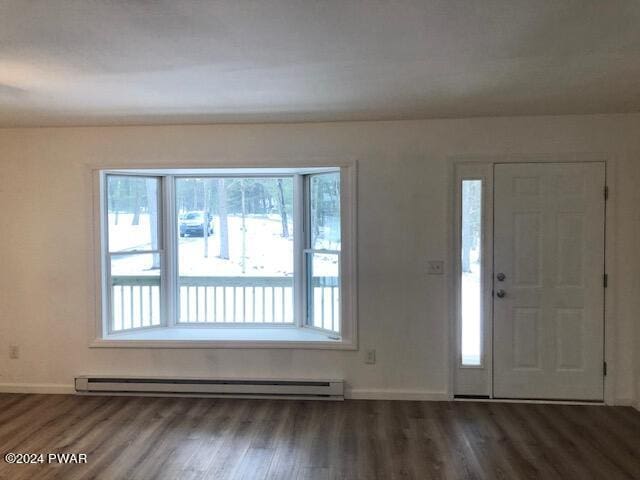 entrance foyer with dark wood-type flooring, a wealth of natural light, and a baseboard heating unit