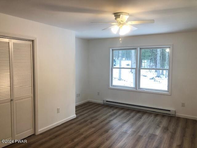 interior space with ceiling fan, dark hardwood / wood-style flooring, and baseboard heating