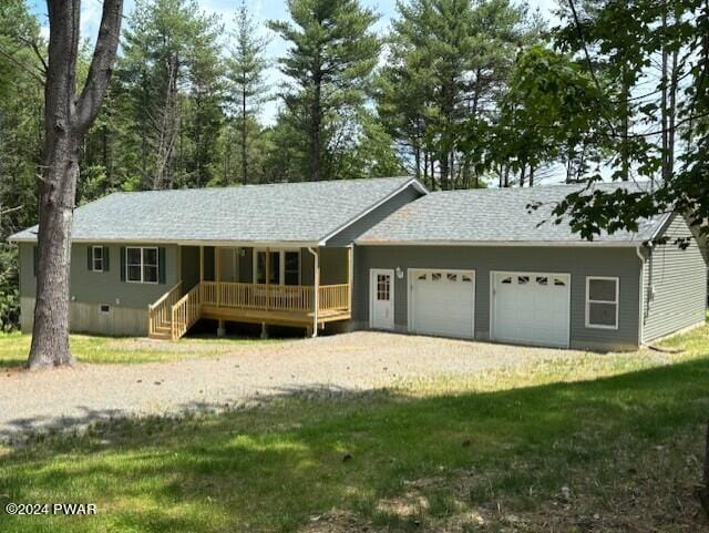 single story home with a front yard and a garage